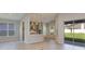 Bright, open-concept living space with modern kitchen, tile floors, and sliding glass doors to the backyard at 4147 Coral Harbour Rd, Kissimmee, FL 34758