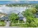 An aerial view of a beautiful blue home with lake access and lush green surroundings at 417 Barclay Ave, Altamonte Springs, FL 32701