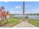 Landscaped backyard features stone patio, views of the lake, a covered boat dock, and beautiful landscaping at 417 Barclay Ave, Altamonte Springs, FL 32701