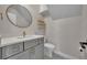 Elegant bathroom with grey vanity, gold accents, round mirror, and stylish hexagon tile floor at 417 Barclay Ave, Altamonte Springs, FL 32701