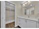 Bright bathroom with a white vanity, modern light fixtures, and a view into the walk-in closet at 417 Barclay Ave, Altamonte Springs, FL 32701