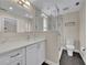 Bathroom with vanity, white cabinets, toilet, and a walk-in shower with glass divider at 417 Barclay Ave, Altamonte Springs, FL 32701
