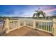 Wide view of the wooden deck with white railing overlooking the lake and surrounding trees at 417 Barclay Ave, Altamonte Springs, FL 32701