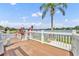 Lovely view from the wooden deck with white railings and scenic view of the lake and lush landscaping at 417 Barclay Ave, Altamonte Springs, FL 32701