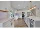 Modern kitchen with white cabinets, stainless steel appliances, and a gray center island at 417 Barclay Ave, Altamonte Springs, FL 32701