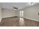 Bright living room with wood floors, a modern ceiling fan, and sliding door to deck at 417 Barclay Ave, Altamonte Springs, FL 32701