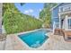 Backyard featuring a sparkling pool, a privacy hedge, and the rear of the home at 417 Barclay Ave, Altamonte Springs, FL 32701