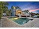 Backyard at dusk showcasing a beautiful blue pool, large deck, and multi-story home at 417 Barclay Ave, Altamonte Springs, FL 32701