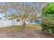 The backyard shows a pool area, partial fencing, sparse grass, with mature landscaping enhancing the outdoor appeal at 4729 Arrow Rd, Orlando, FL 32812