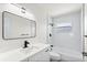 Stylish bathroom featuring modern vanity, black hardware, shower with white subway tile, and a window at 4729 Arrow Rd, Orlando, FL 32812