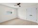 Bright bedroom featuring a ceiling fan, window, neutral walls, and light-colored wood-look flooring at 4729 Arrow Rd, Orlando, FL 32812