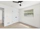 Bright bedroom featuring a ceiling fan, window, neutral walls, and light-colored wood-look flooring at 4729 Arrow Rd, Orlando, FL 32812