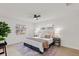 Bright bedroom with a ceiling fan, and a view of the front yard through the windows at 4729 Arrow Rd, Orlando, FL 32812