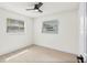 Bright bedroom featuring a ceiling fan, two windows, neutral walls, and light-colored wood-look flooring at 4729 Arrow Rd, Orlando, FL 32812