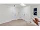 Inviting entryway with modern lighting, artwork, neutral walls, and wood-look floors offers a stylish welcome at 4729 Arrow Rd, Orlando, FL 32812