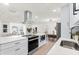 Modern kitchen boasts bright countertops, a stainless sink, sleek appliances, and a breakfast bar for casual dining at 4729 Arrow Rd, Orlando, FL 32812