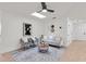 Bright living room featuring modern decor, light wood floors, and a contemporary ceiling fan at 4729 Arrow Rd, Orlando, FL 32812