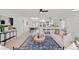 Open floor plan seamlessly connecting the living room, kitchen, and dining area for modern living at 4729 Arrow Rd, Orlando, FL 32812