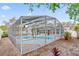 Enclosed pool area with a uniquely shaped pool, palm trees, and a surrounding patio for relaxation at 4729 Arrow Rd, Orlando, FL 32812