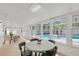 Enclosed sunroom overlooking the pool; features dining table, chairs, and light-colored flooring at 4729 Arrow Rd, Orlando, FL 32812