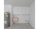 The utility area includes a utility sink, cabinetry for storage, and hookups for laundry appliances at 4729 Arrow Rd, Orlando, FL 32812