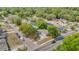 Aerial view of the home on a street corner surrounded by lush greenery at 5201 Van Aken Dr, Orlando, FL 32808