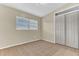 Neutral bedroom features tile floors, a window with blinds, and a closet with double doors at 5201 Van Aken Dr, Orlando, FL 32808
