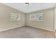 Empty neutral bedroom features tile floors and bright natural light from two windows at 5201 Van Aken Dr, Orlando, FL 32808