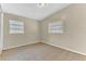 Neutral bedroom features tile floors, two windows with blinds, and ample space at 5201 Van Aken Dr, Orlando, FL 32808