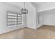 Bright dining room featuring tile floors, a modern chandelier, and large windows for ample natural light at 5201 Van Aken Dr, Orlando, FL 32808