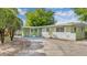 Inviting single-story home with a long driveway and well-maintained landscaping at 5201 Van Aken Dr, Orlando, FL 32808
