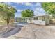 View of the front exterior with extended driveway at 5201 Van Aken Dr, Orlando, FL 32808