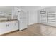 Bright kitchen with stainless steel sink, stone countertops, and white cabinetry and appliances at 5201 Van Aken Dr, Orlando, FL 32808