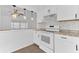 Well-appointed kitchen with white cabinetry, modern lighting, and stainless steel appliances at 5201 Van Aken Dr, Orlando, FL 32808