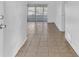 Neutral living area with tile floors and sliding glass door to the outside at 5201 Van Aken Dr, Orlando, FL 32808