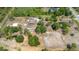 High aerial view showcases property's layout, which includes a home, outbuildings, acreage, and mature trees at 5242 Bancroft Blvd, Orlando, FL 32833