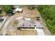 Aerial view shows the house, and outbuildings with a long driveway at 5242 Bancroft Blvd, Orlando, FL 32833