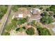 Aerial view of the house, barn, and pond featuring mature trees at 5242 Bancroft Blvd, Orlando, FL 32833