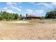 Expansive backyard with a partial privacy fence and mature trees surrounding the property at 5242 Bancroft Blvd, Orlando, FL 32833