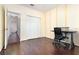 Bedroom with desk, dark floors, large closet and neutral colored walls at 5242 Bancroft Blvd, Orlando, FL 32833
