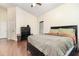 Bedroom with wood floors, ceiling fan, and ample storage space with closets and dressers at 5242 Bancroft Blvd, Orlando, FL 32833