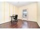 Well-lit bedroom featuring hardwood floors, a large window, and a black office chair at a desk at 5242 Bancroft Blvd, Orlando, FL 32833