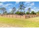 Well-maintained grassy front yard with a rustic wood fence showcasing the property's expansive outdoor space at 5242 Bancroft Blvd, Orlando, FL 32833