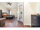 Main bedroom boasts wood floors, a ceiling fan, and an ensuite bathroom with a glass shower at 5242 Bancroft Blvd, Orlando, FL 32833