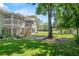 Exterior view of the house featuring a well-maintained lawn and beautiful landscaping at 5258 Tunbridge Wells Ln # 4, Orlando, FL 32812