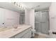 Bathroom featuring a vanity with marble countertops, large mirror, and a glass-enclosed shower at 5258 Tunbridge Wells Ln # 4, Orlando, FL 32812