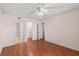 Spacious bedroom featuring wood floors, ceiling fan, and access to an ensuite bathroom at 5258 Tunbridge Wells Ln # 4, Orlando, FL 32812