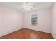 This bedroom features hardwood floors, a ceiling fan, and a window to provide plenty of natural light at 5258 Tunbridge Wells Ln # 4, Orlando, FL 32812