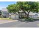 Charming townhome featuring a well-maintained exterior and mature trees, showcasing a welcoming curb appeal at 5258 Tunbridge Wells Ln # 4, Orlando, FL 32812