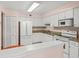A well-lit kitchen with white cabinets, granite countertops, and modern appliances at 5258 Tunbridge Wells Ln # 4, Orlando, FL 32812